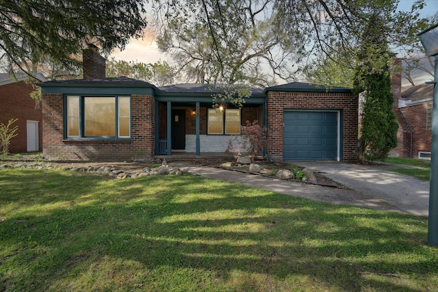 ranch-style home featuring a yard and a garage