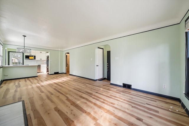 unfurnished living room with light wood-type flooring