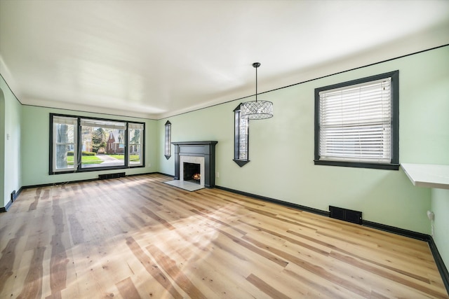 unfurnished living room with light hardwood / wood-style flooring