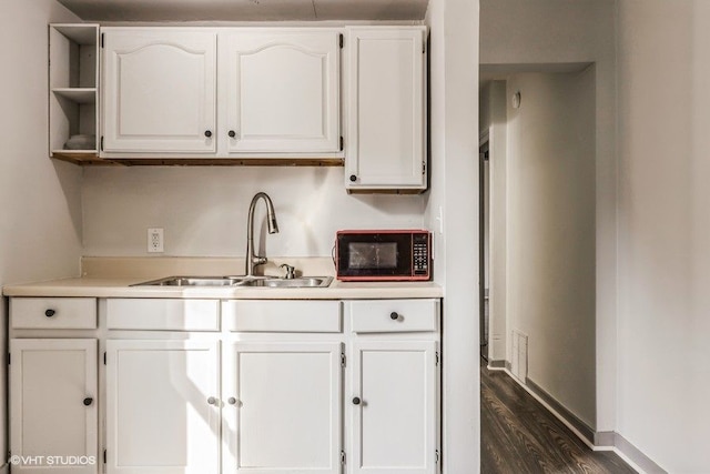 bar with white cabinetry, dark wood-type flooring, and sink