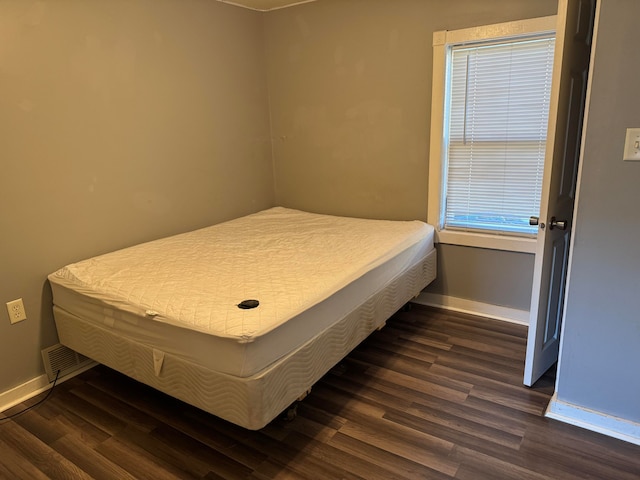 bedroom featuring dark wood-type flooring