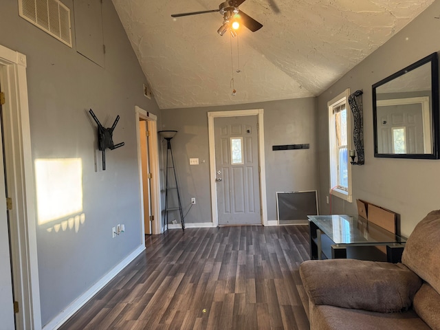 entryway featuring a wealth of natural light, dark hardwood / wood-style flooring, ceiling fan, and vaulted ceiling