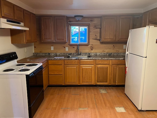 kitchen featuring sink, white appliances, and light hardwood / wood-style flooring