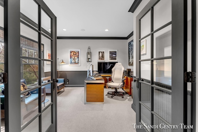 carpeted office space featuring french doors, wooden walls, and ornamental molding