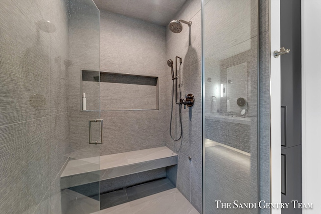 bathroom featuring a shower with shower door