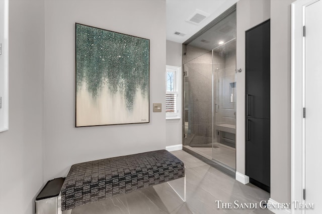 bathroom featuring tile patterned floors and an enclosed shower