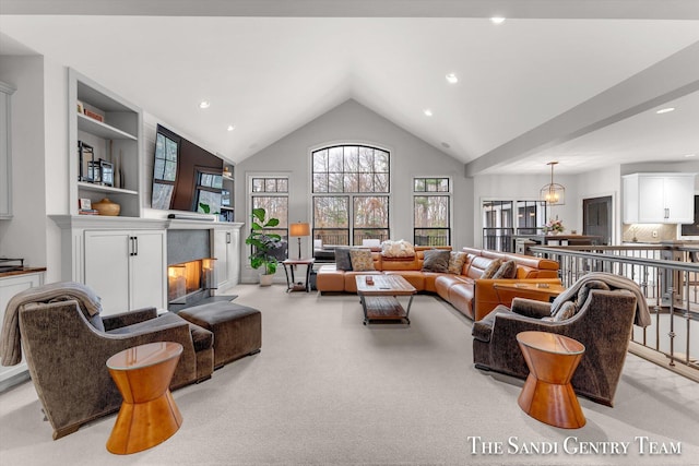 carpeted living room featuring high vaulted ceiling and a notable chandelier