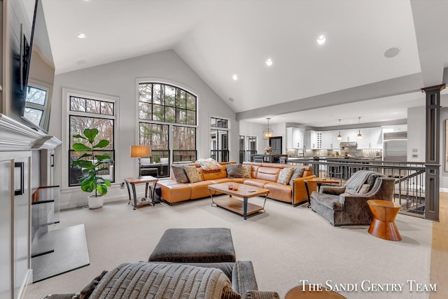 living room featuring light carpet and high vaulted ceiling