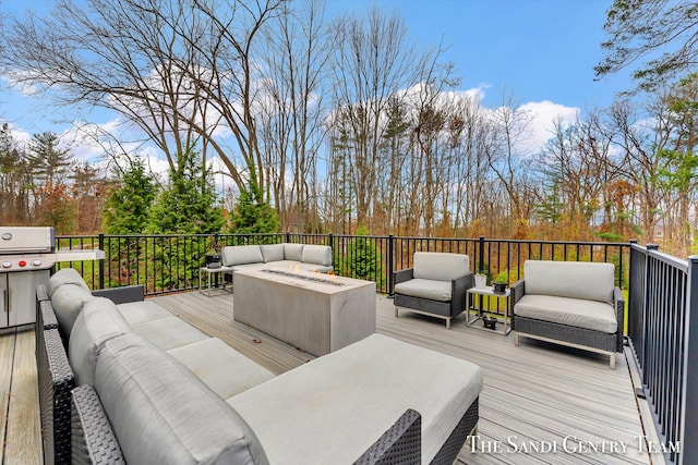 wooden deck featuring a grill and an outdoor hangout area