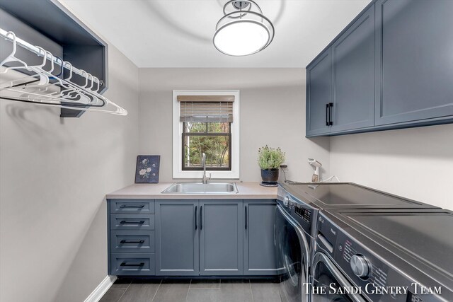 laundry room with cabinets, separate washer and dryer, and sink