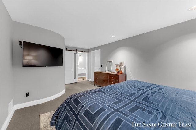 carpeted bedroom featuring a barn door