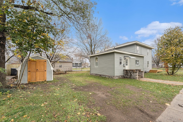 view of property exterior with a storage unit and a lawn