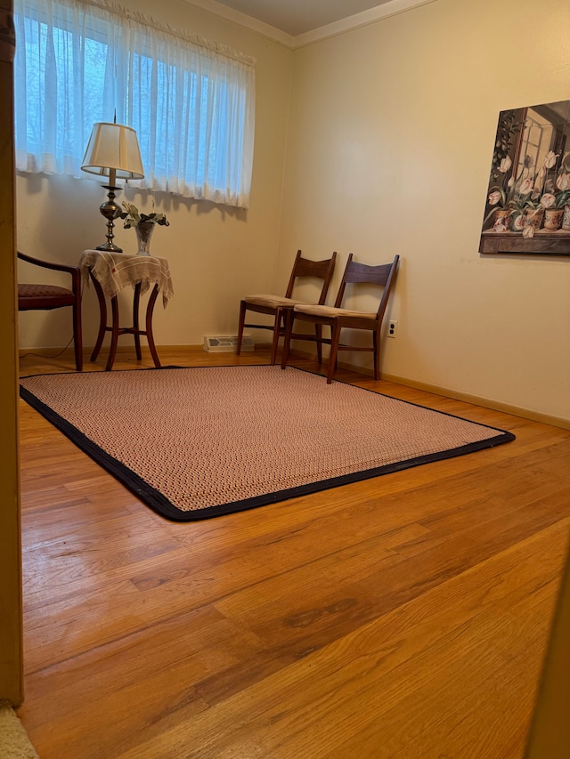 sitting room featuring crown molding and hardwood / wood-style floors