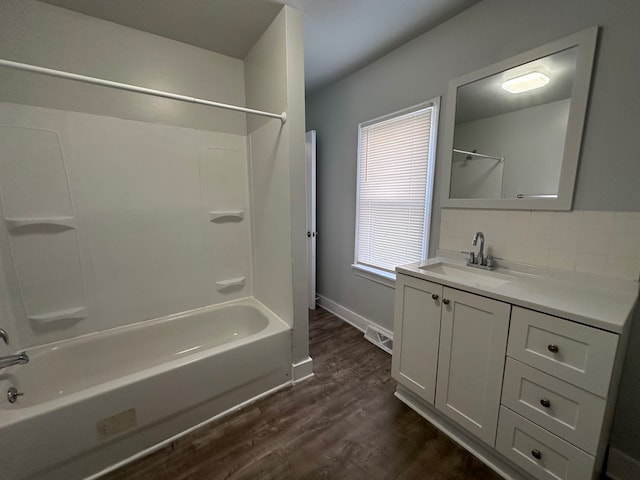 bathroom featuring wood-type flooring, vanity, and tub / shower combination