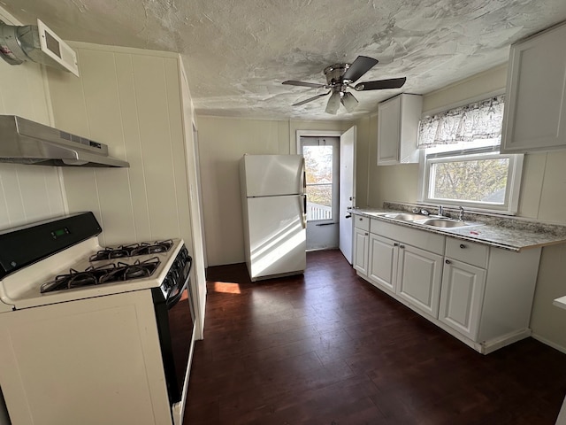 kitchen featuring dark hardwood / wood-style flooring, white appliances, sink, white cabinetry, and range hood