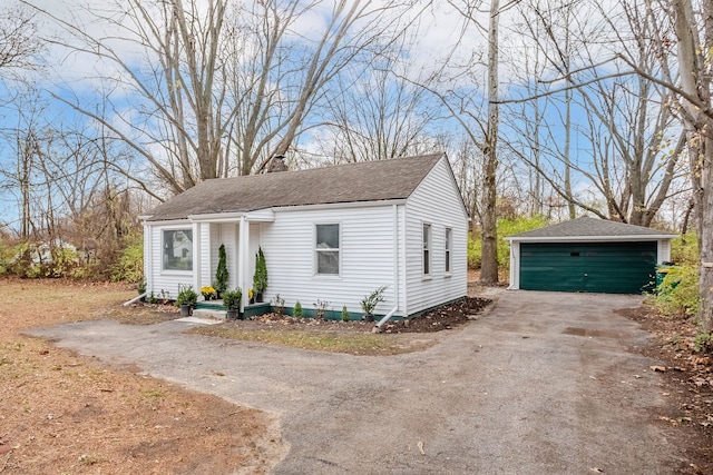 bungalow-style house featuring an outbuilding and a garage