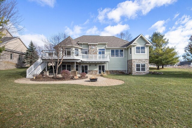 11325 Killarney Dr, Stanwood, MI 49346 - back of property featuring stone siding, a lawn, a wooden deck, a patio area, and stairs
