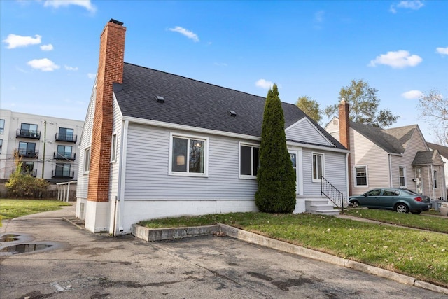 rear view of property with a yard