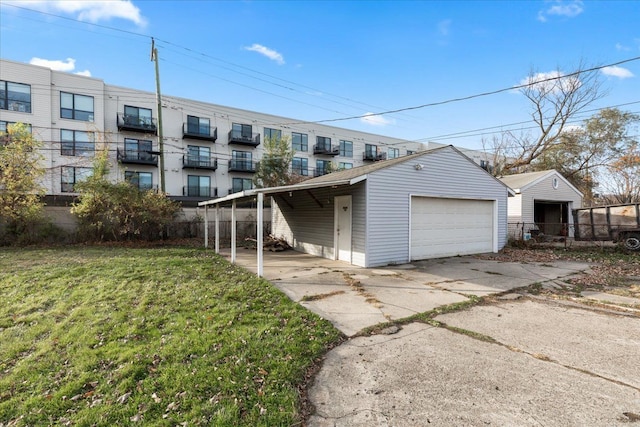 exterior space with an outbuilding, a front yard, and a garage