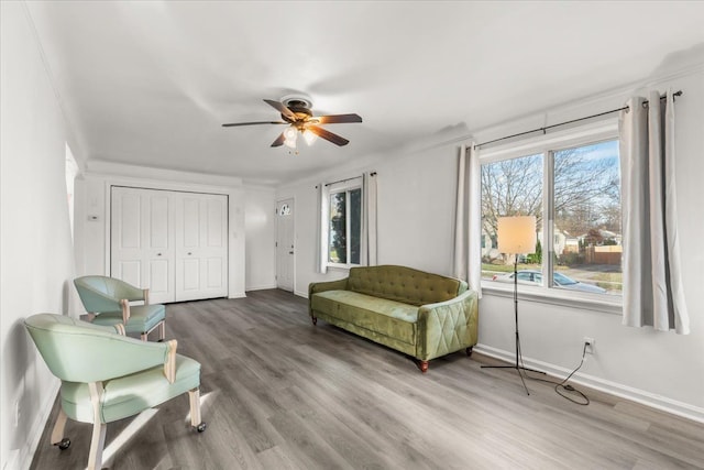 living area featuring hardwood / wood-style floors and ceiling fan