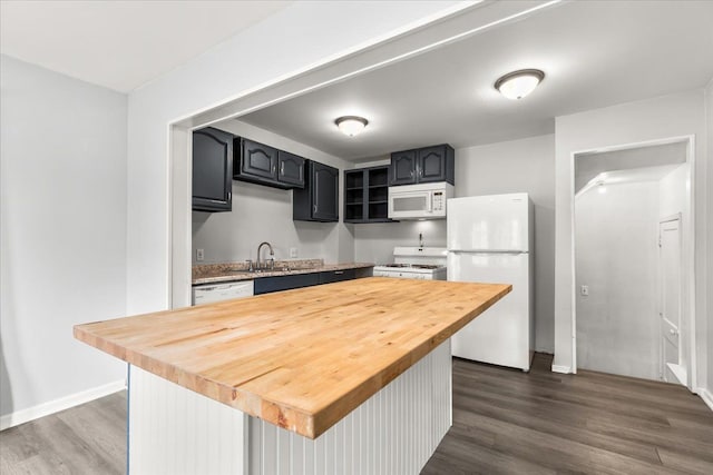 kitchen with dark hardwood / wood-style floors, butcher block counters, white appliances, and sink