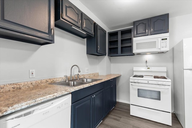 kitchen featuring white appliances, dark hardwood / wood-style floors, and sink