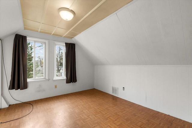 additional living space featuring light parquet flooring and lofted ceiling