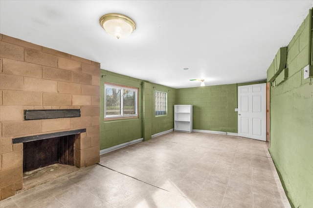 unfurnished living room with a tile fireplace