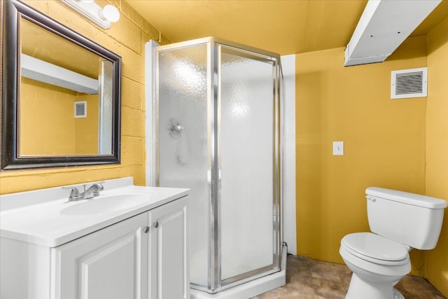 bathroom featuring vanity, toilet, and a shower with shower door