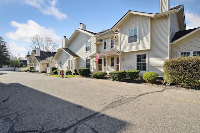 view of front of house featuring a residential view and a chimney
