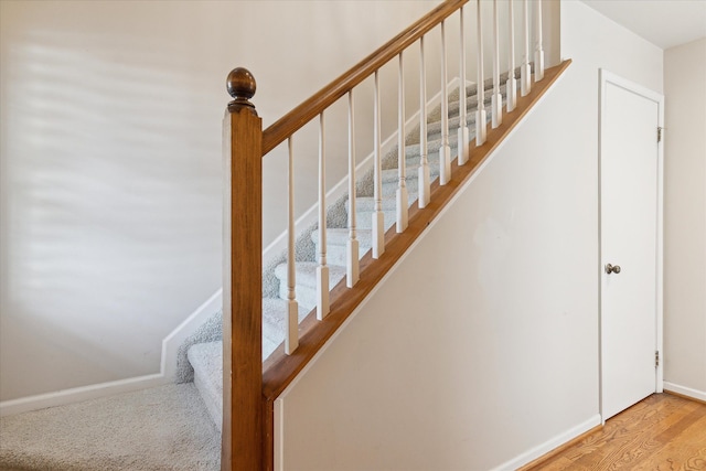stairs with baseboards and wood finished floors