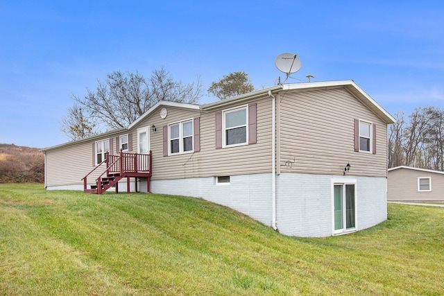 rear view of house featuring a lawn