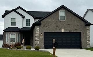 view of front of property with a front yard and a garage