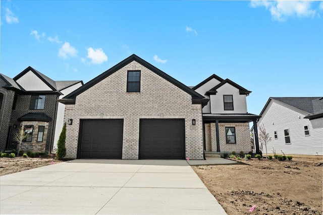 36135 Parkdale St Unit 5, Livonia, MI 48150 - view of front of home featuring driveway, brick siding, and covered porch