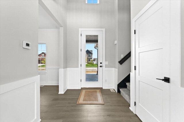 36135 Parkdale St Unit 5, Livonia, MI 48150 - entrance foyer featuring wood finished floors, wainscoting, a high ceiling, and stairway