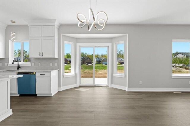 36135 Parkdale St Unit 5, Livonia, MI 48150 - doorway to outside featuring a sink, a chandelier, dark wood-type flooring, and baseboards