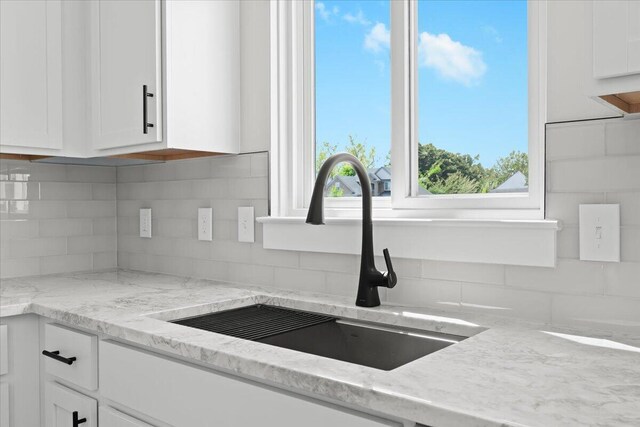 36135 Parkdale St Unit 5, Livonia, MI 48150 - kitchen with a sink, white cabinetry, and backsplash