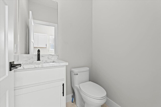 36135 Parkdale St Unit 5, Livonia, MI 48150 - half bathroom featuring toilet, vanity, and baseboards