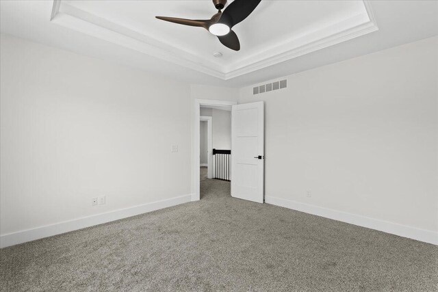 36135 Parkdale St Unit 5, Livonia, MI 48150 - carpeted spare room featuring a raised ceiling, baseboards, and a ceiling fan