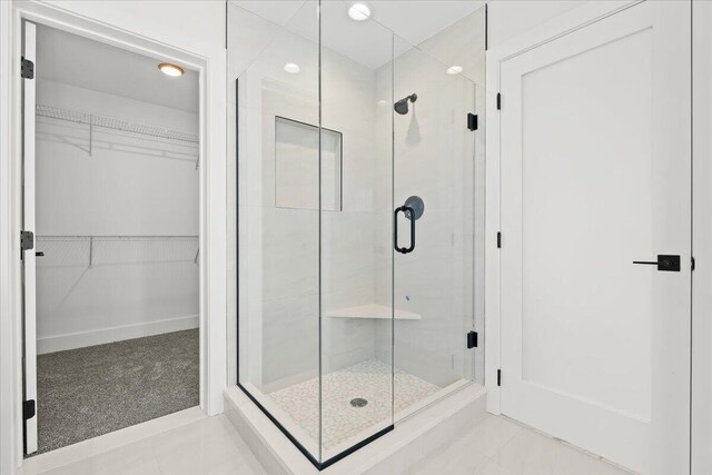 36135 Parkdale St Unit 5, Livonia, MI 48150 - bathroom featuring a stall shower, a walk in closet, and recessed lighting