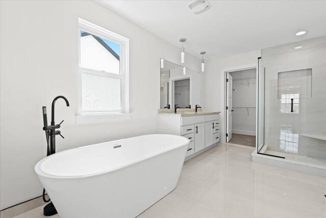 36135 Parkdale St Unit 5, Livonia, MI 48150 - full bathroom featuring vanity, a shower stall, a freestanding tub, a spacious closet, and recessed lighting