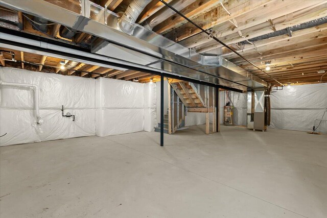 36135 Parkdale St Unit 5, Livonia, MI 48150 - unfinished below grade area with water heater, heating unit, and stairway