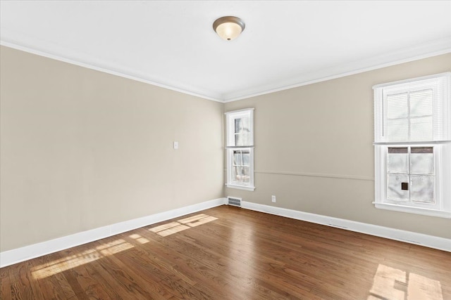 unfurnished room featuring hardwood / wood-style floors and crown molding