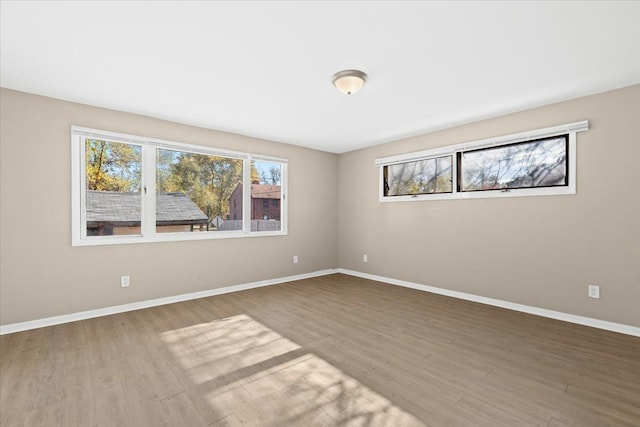 unfurnished room with hardwood / wood-style flooring