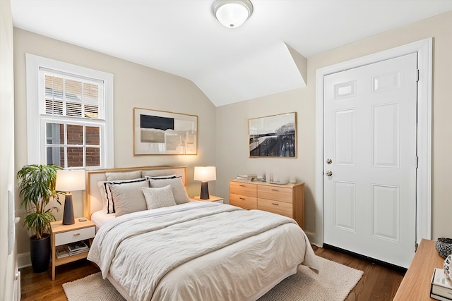 bedroom featuring dark hardwood / wood-style floors and lofted ceiling