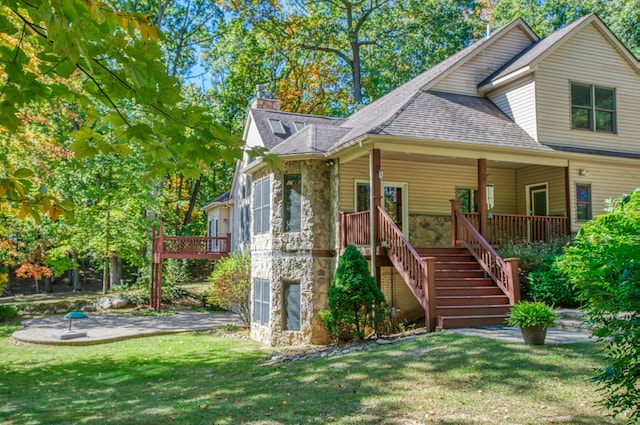 3592 Hillandale Dr, Howell, MI 48843 - view of front of house with stone siding, a garage, a chimney, stairs, and a front yard