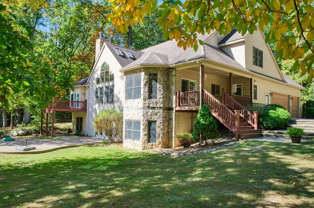 rear view of house with a lawn and a garage