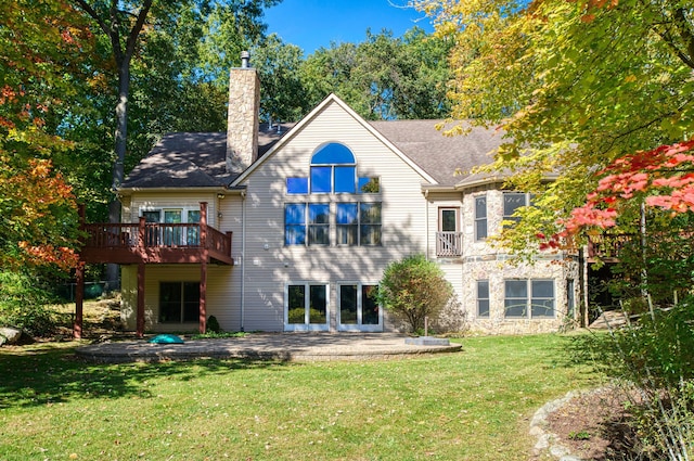 back of property with a patio area, a yard, and a wooden deck