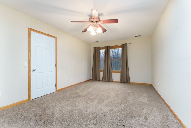 carpeted empty room featuring ceiling fan