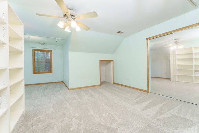 bonus room with light carpet, vaulted ceiling, and ceiling fan